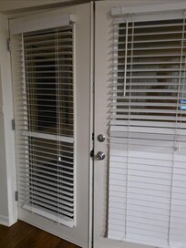 French doors blown inward by wind despite being locked