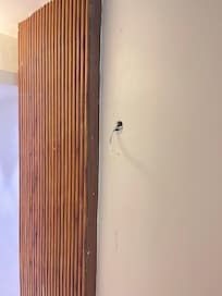 Exposed wires in the hallway posing electrocution risk