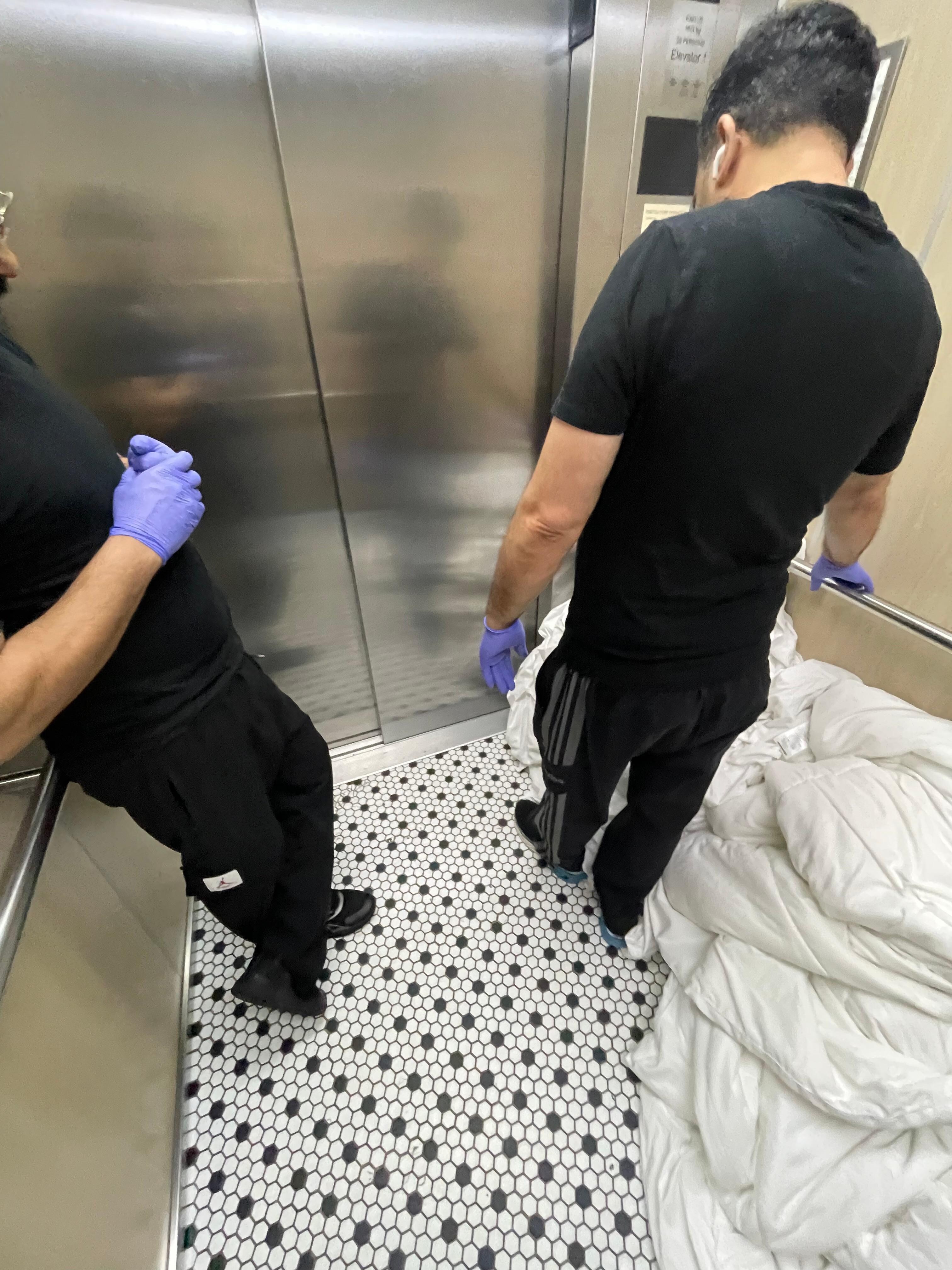 I hope these are dirty sheets being transferred on the floor of the elevator 