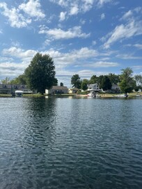 A photo of the house taken from a kayak on the lake.
