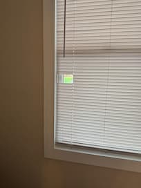 strange hole cut in bathroom blind