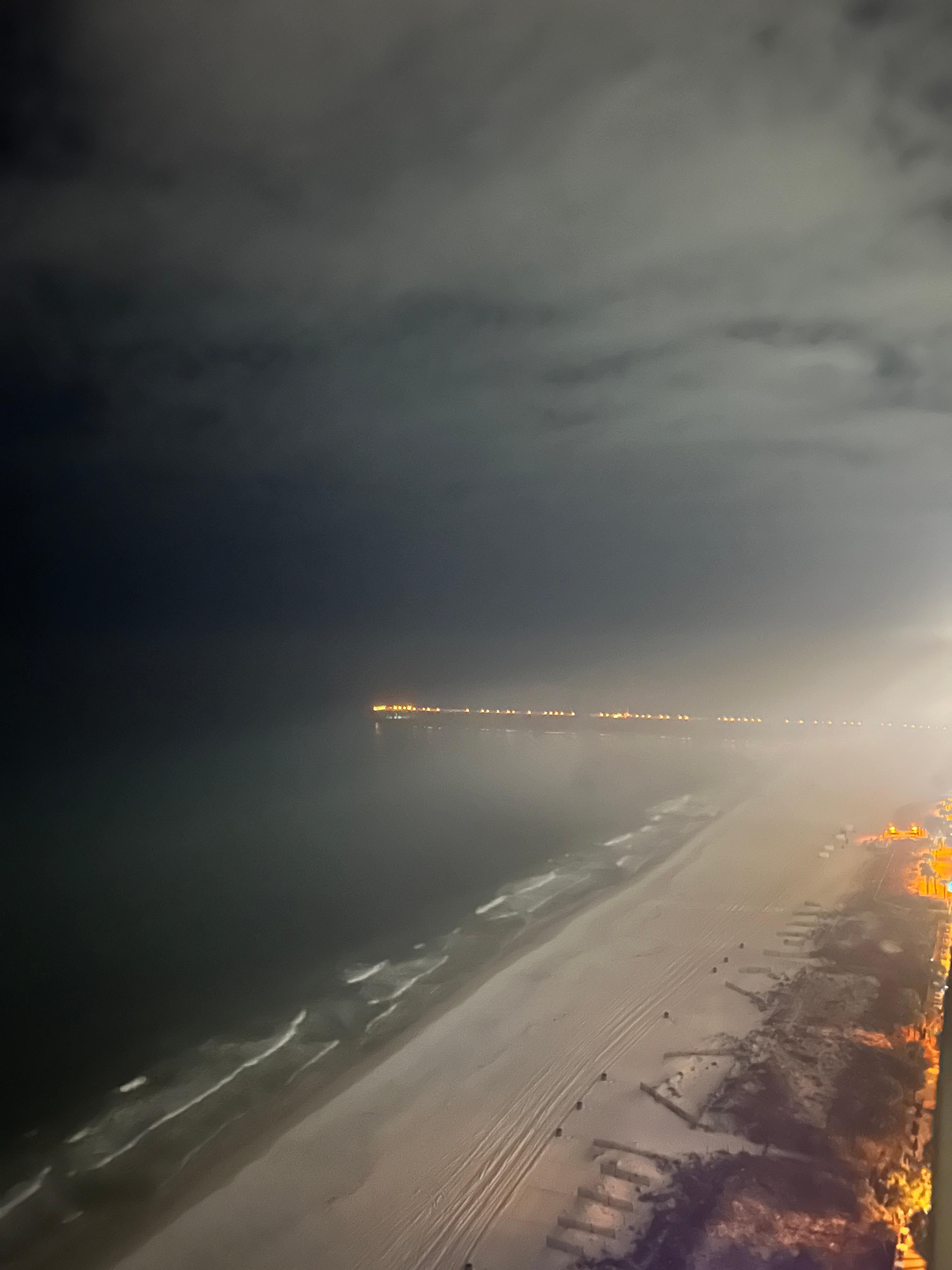 Foggy conditions coupled with lights gave illusion of fire along the shore/pier