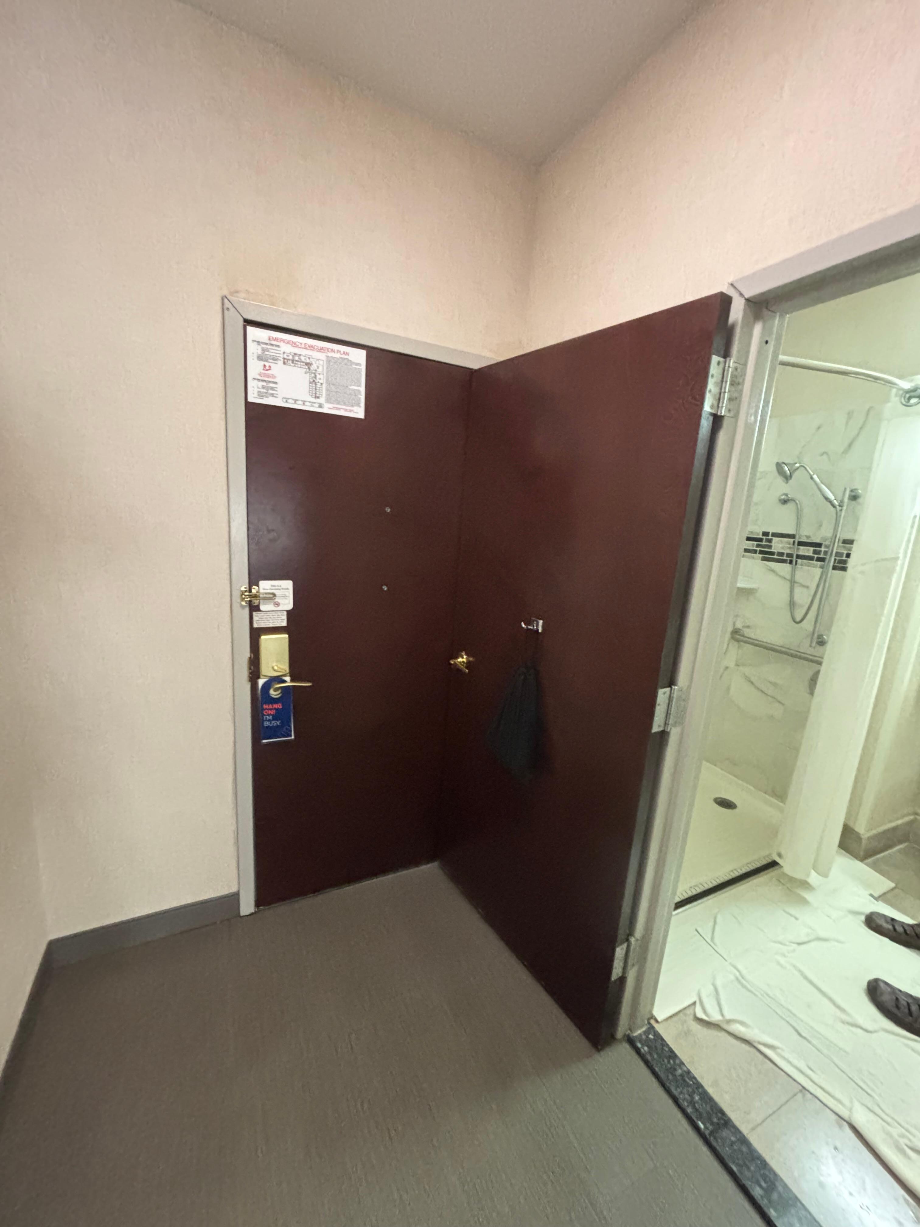 This is a bad design; bathroom door should swing away from main door
