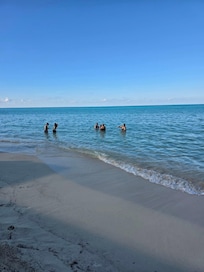 The beach 5 feet in front of the house opposite of the rocks.