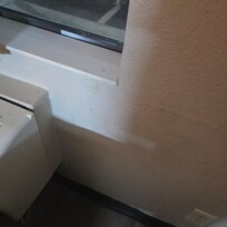 Stains beside ac unit.