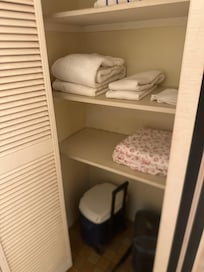 Linen closet with soft fluffy towels, sheets for pull out couch, and coolers for the beach or day trips. Ice packs are in the freezer.