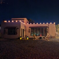 View of home at night with farolitas