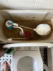 The condition of the toilet that we had to manually fix to get it to flush.