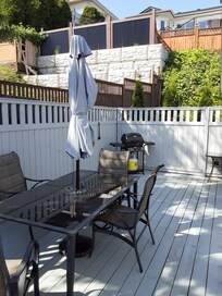 very nice back deck with BBQ and table