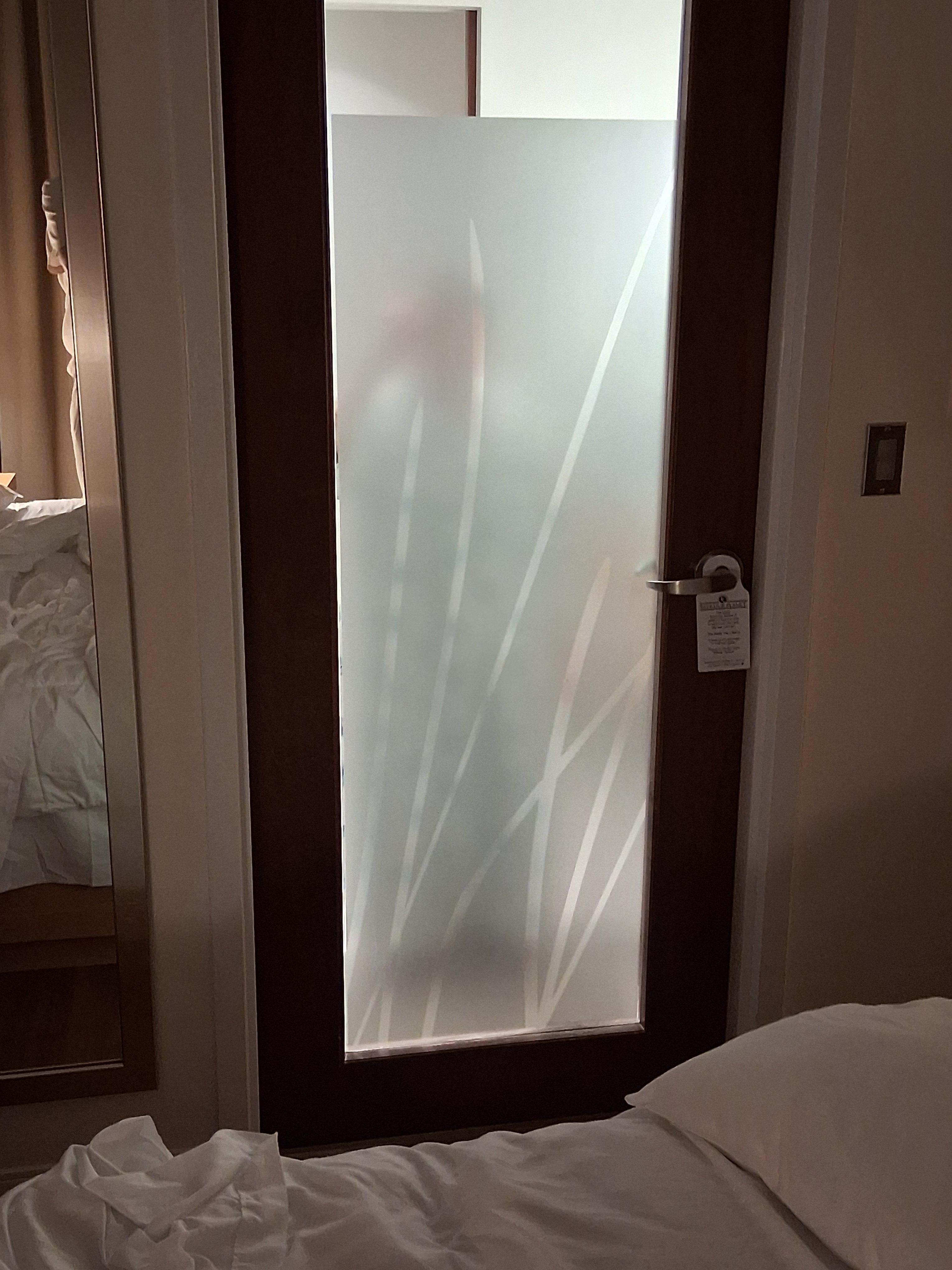 View of bathroom door at night.