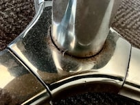 Foot of the table in the room.