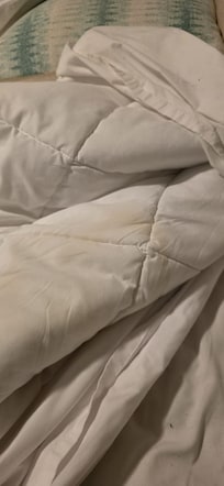 dirty stain marks on bed covers