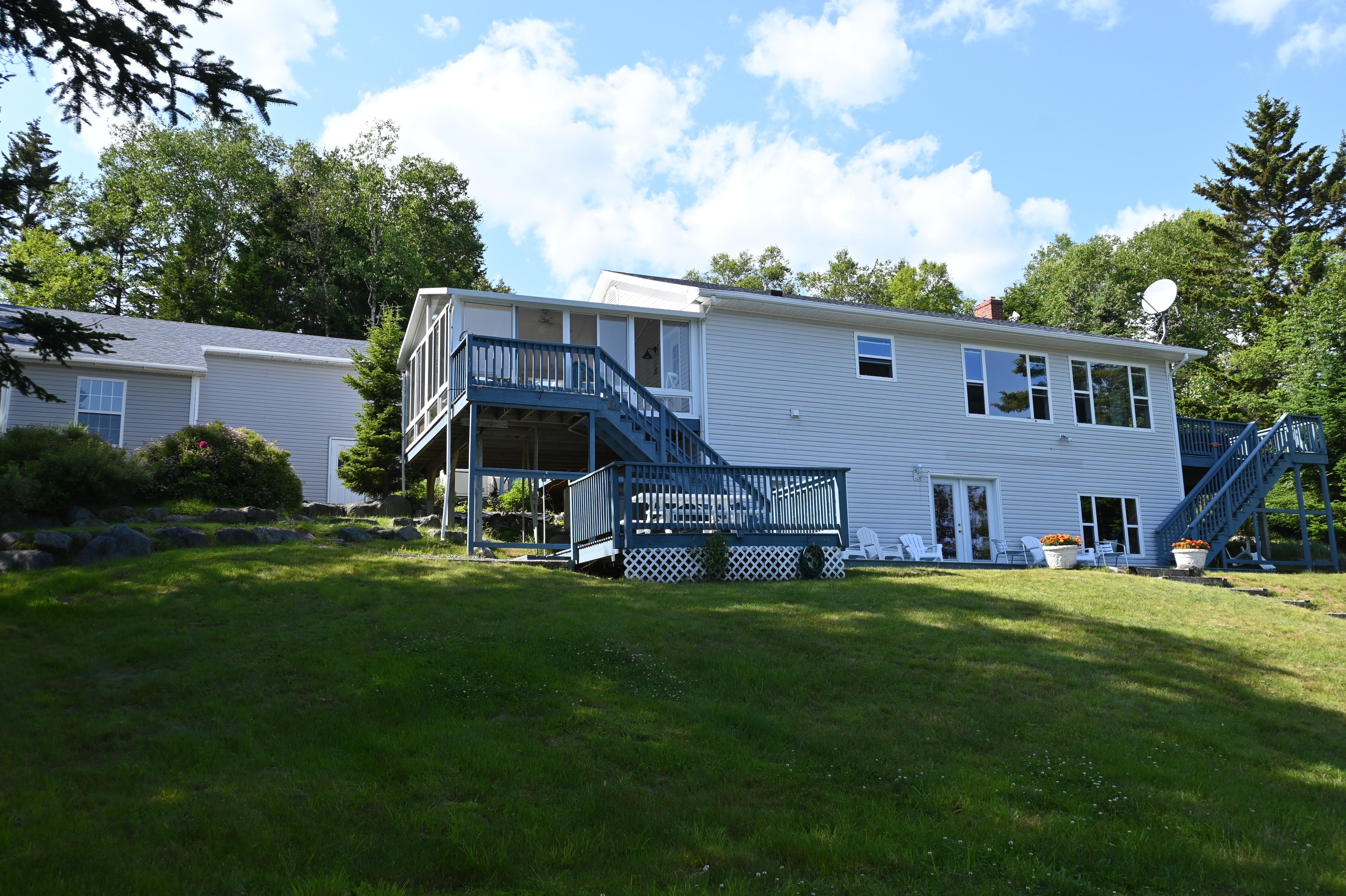 Back, ocean-side of spacious house (garage at left).