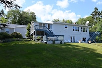 Back, ocean-side of spacious house (garage at left).