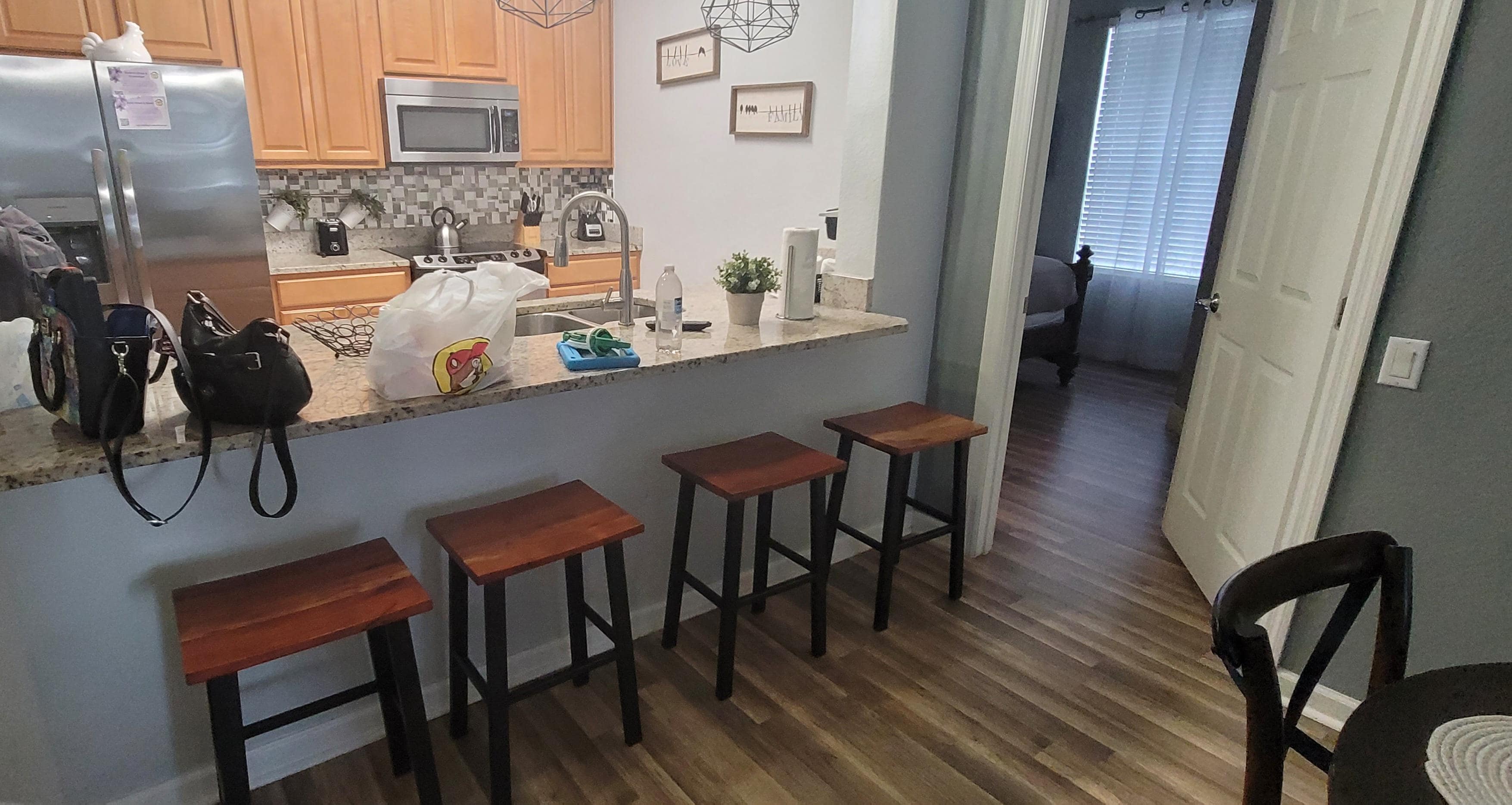 You can see the kitchen area with bar stools and entrance to the room with Queen bed that shares a jack-&-jill bathroom (nice size) with other room that had 2 full beds.