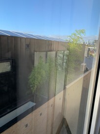 Just a glimpse of the city through a dirty window and flatscreen .