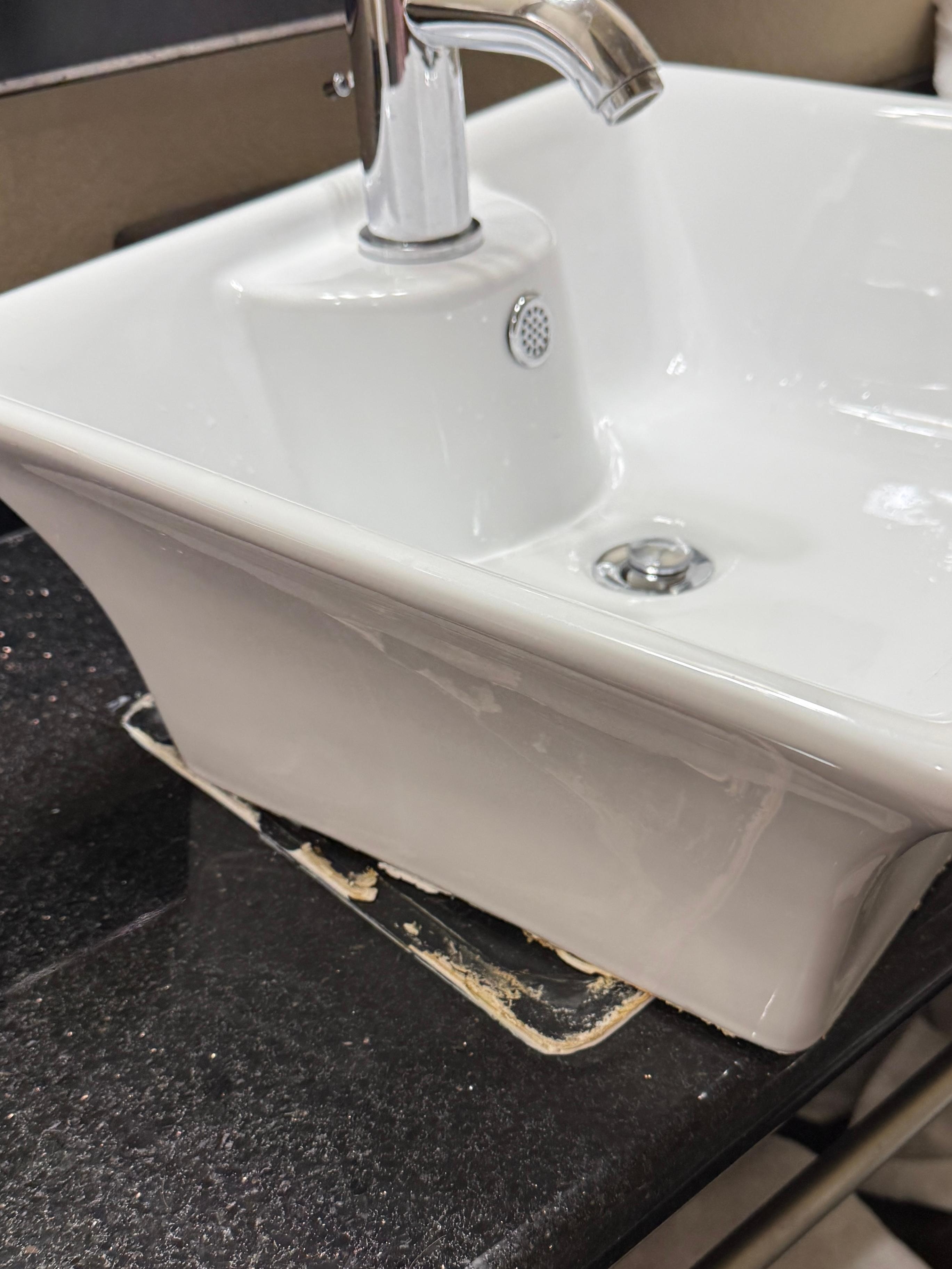 Wet caulk preventing sink from remaining stationary 