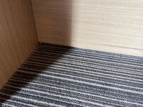 Under the desk there are scraps of paper that missed the bin