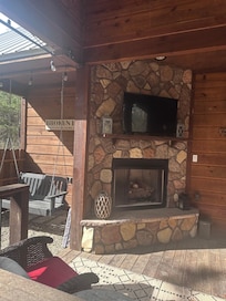 Another picture of outside fireplace, showing the swing