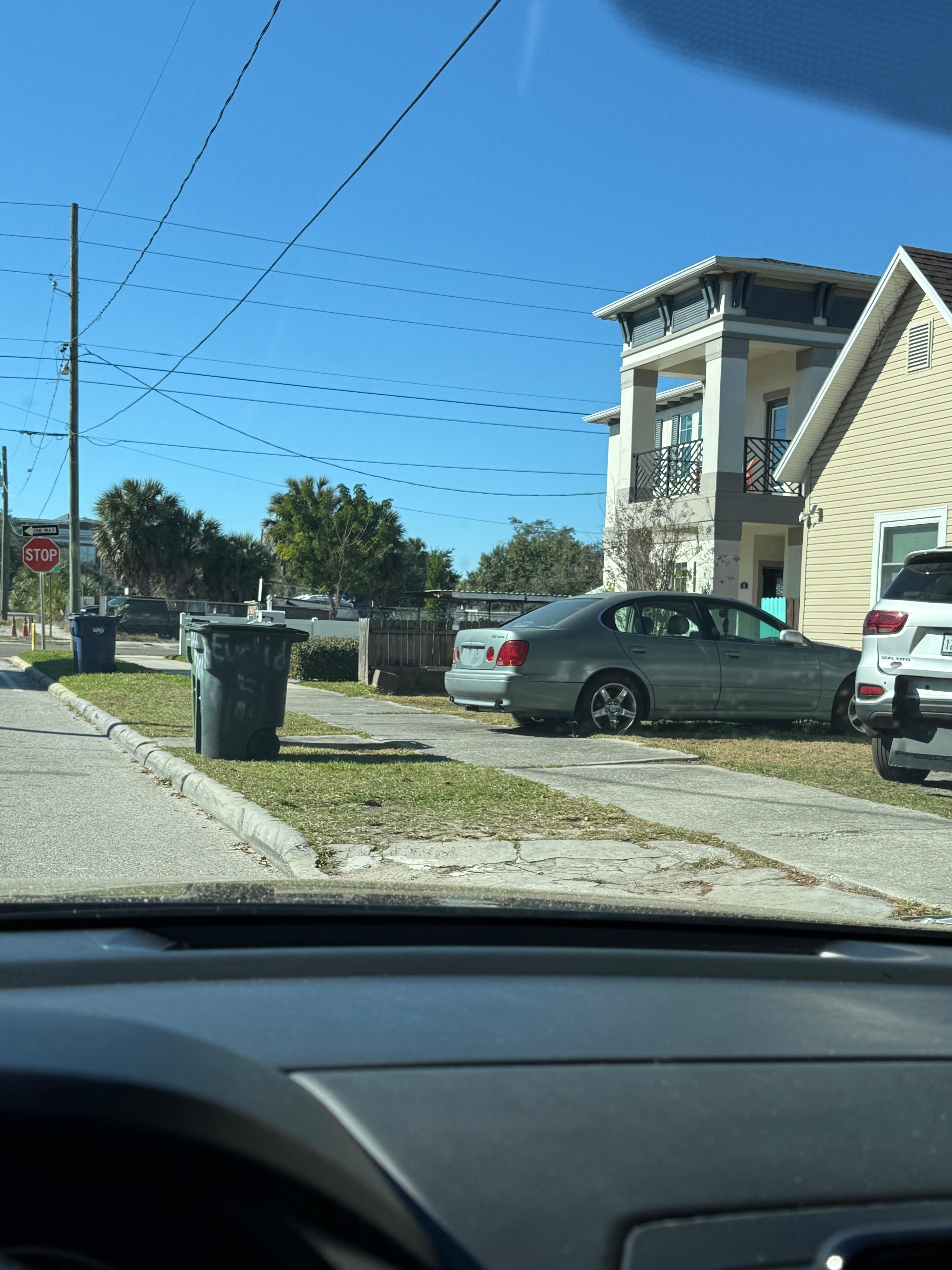Garbage cans in the only way in to park at the entrance to my rental