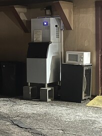 The microwave in the parking lot next to the ice machine.