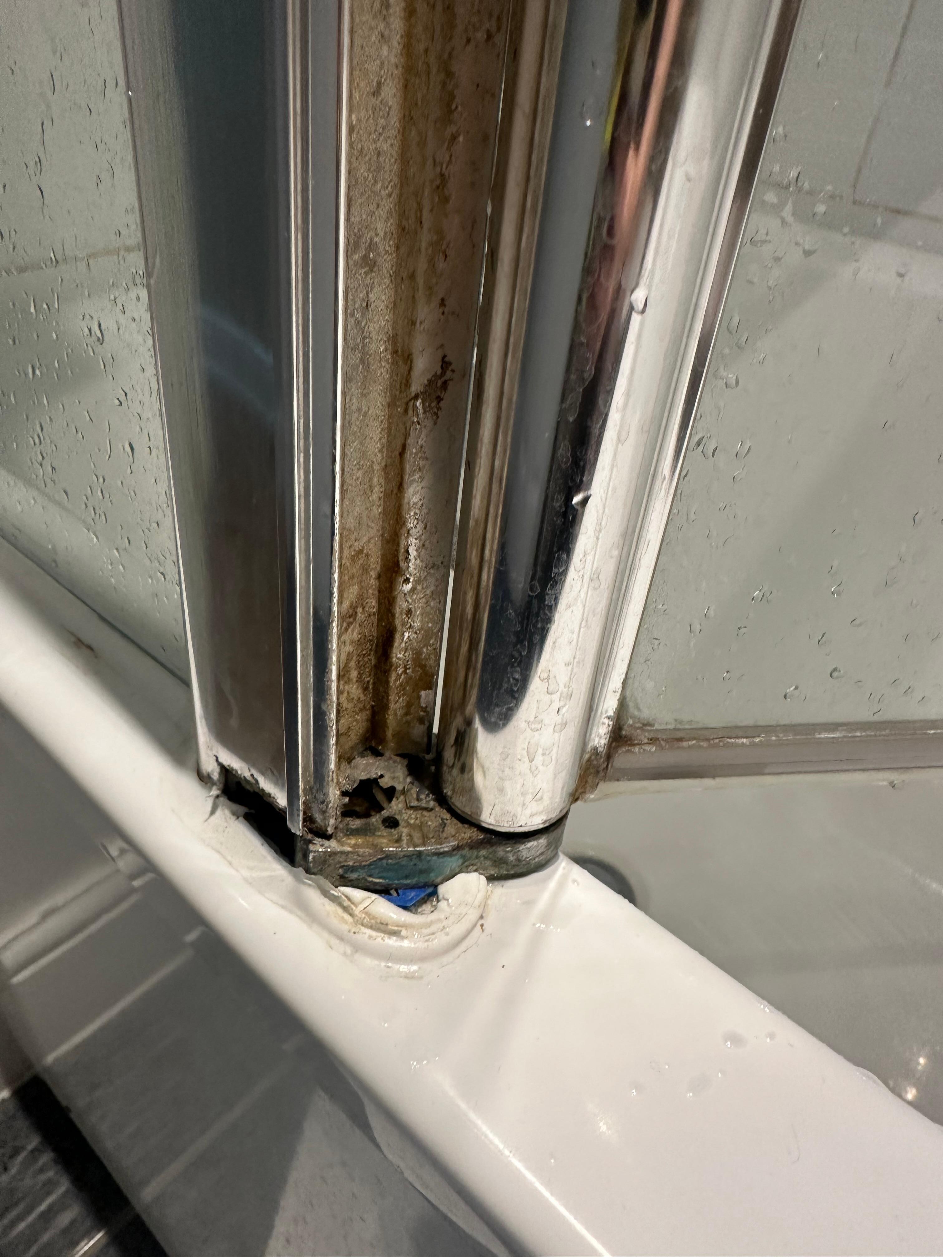 The glass shower door looked like it was about to fall off.