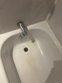 Dirty bath and the faucets is loose also falling off the wall.