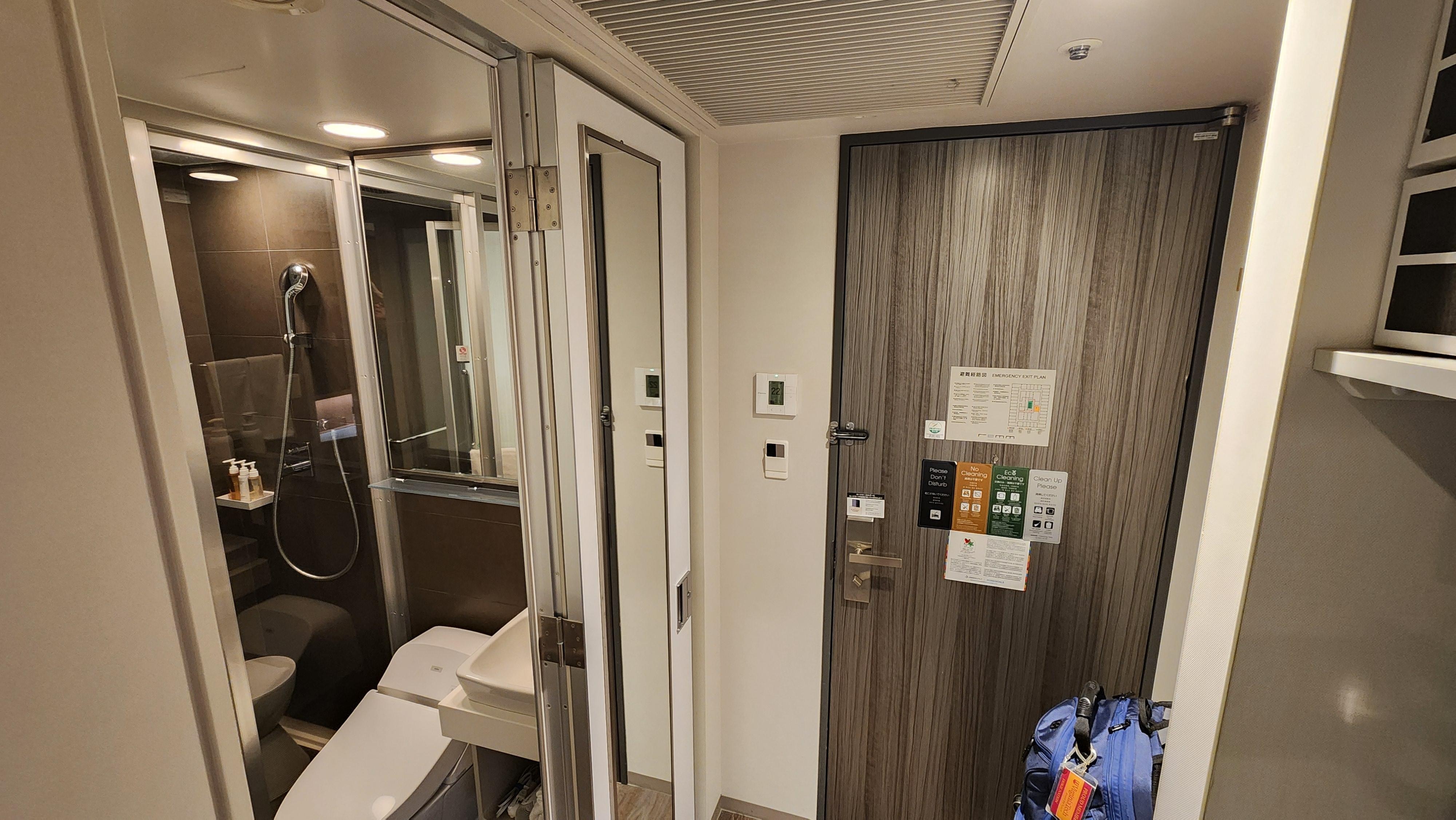 Looking toward the door of the room, bathroom is on the left and the "hangers" are on the right.