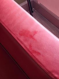 Grease marks on arm of chair in room
