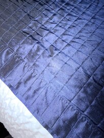Dirty bedding with suspicious white stains.