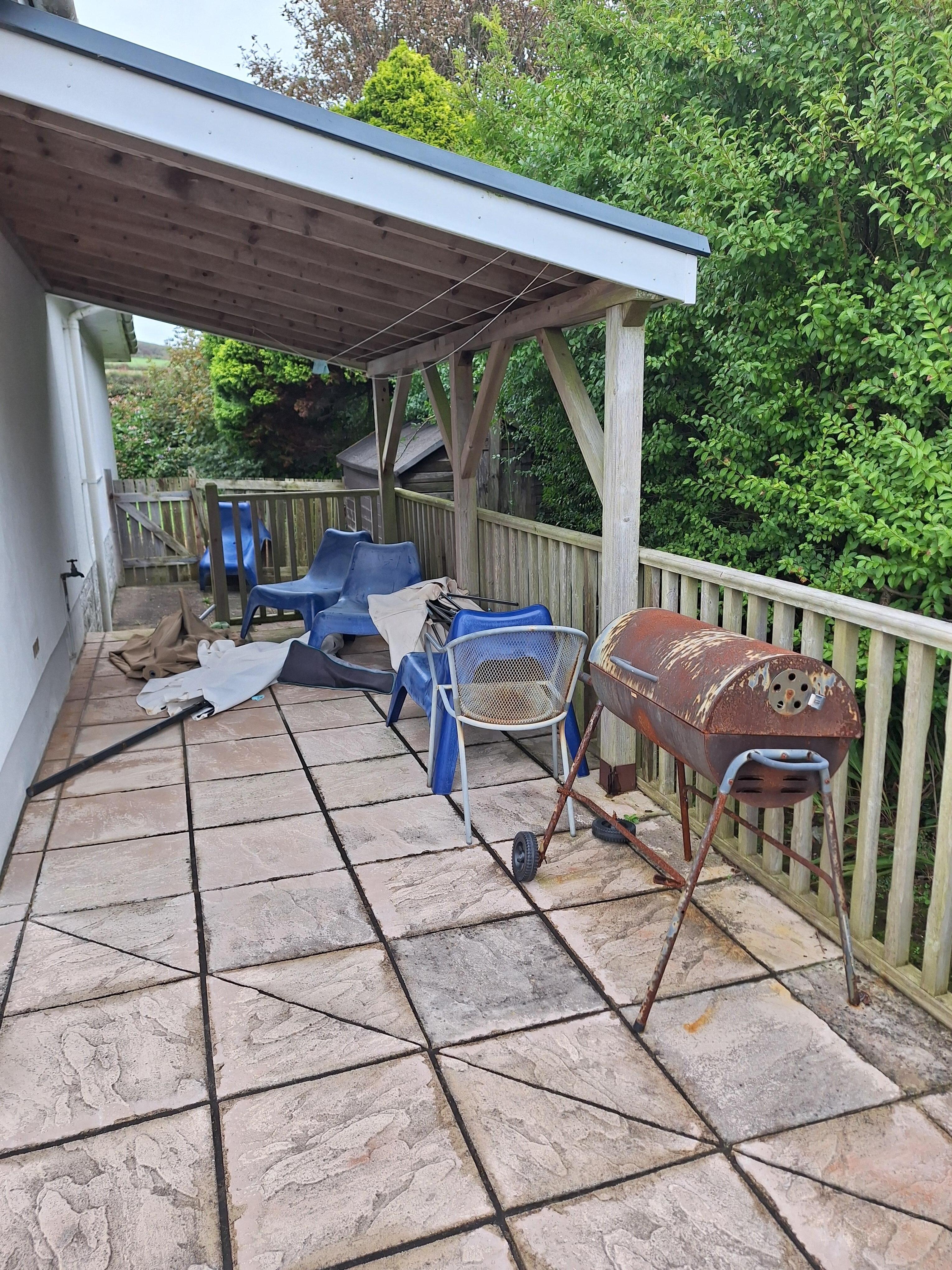 Messy patio, with full dog-poo bag