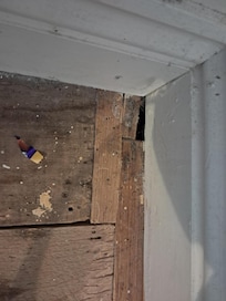 Bare rough floorboards with gaps