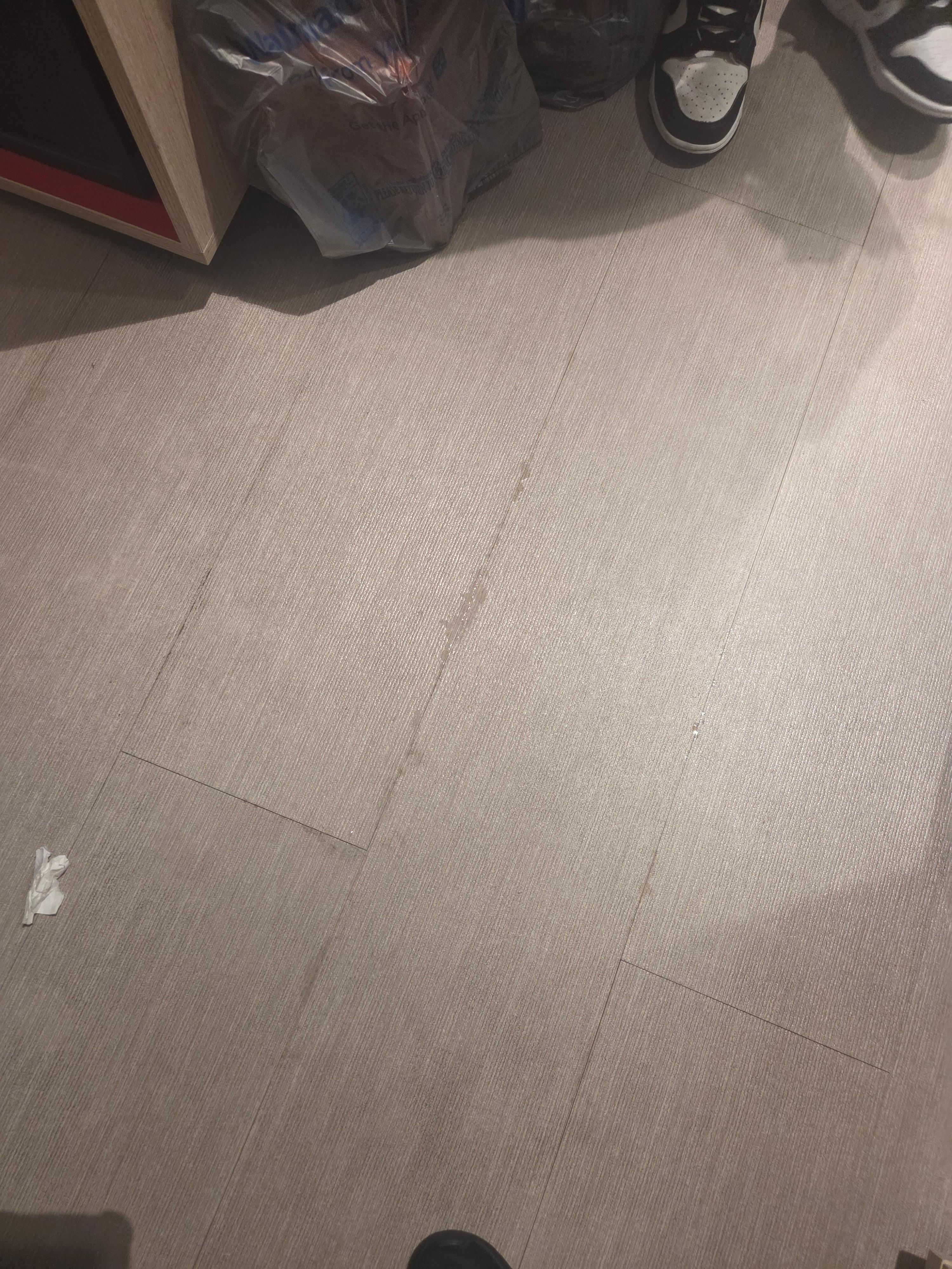 Water coming through floor tiles.