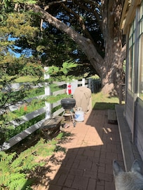 Safe fenced side yards with bbq equipment.