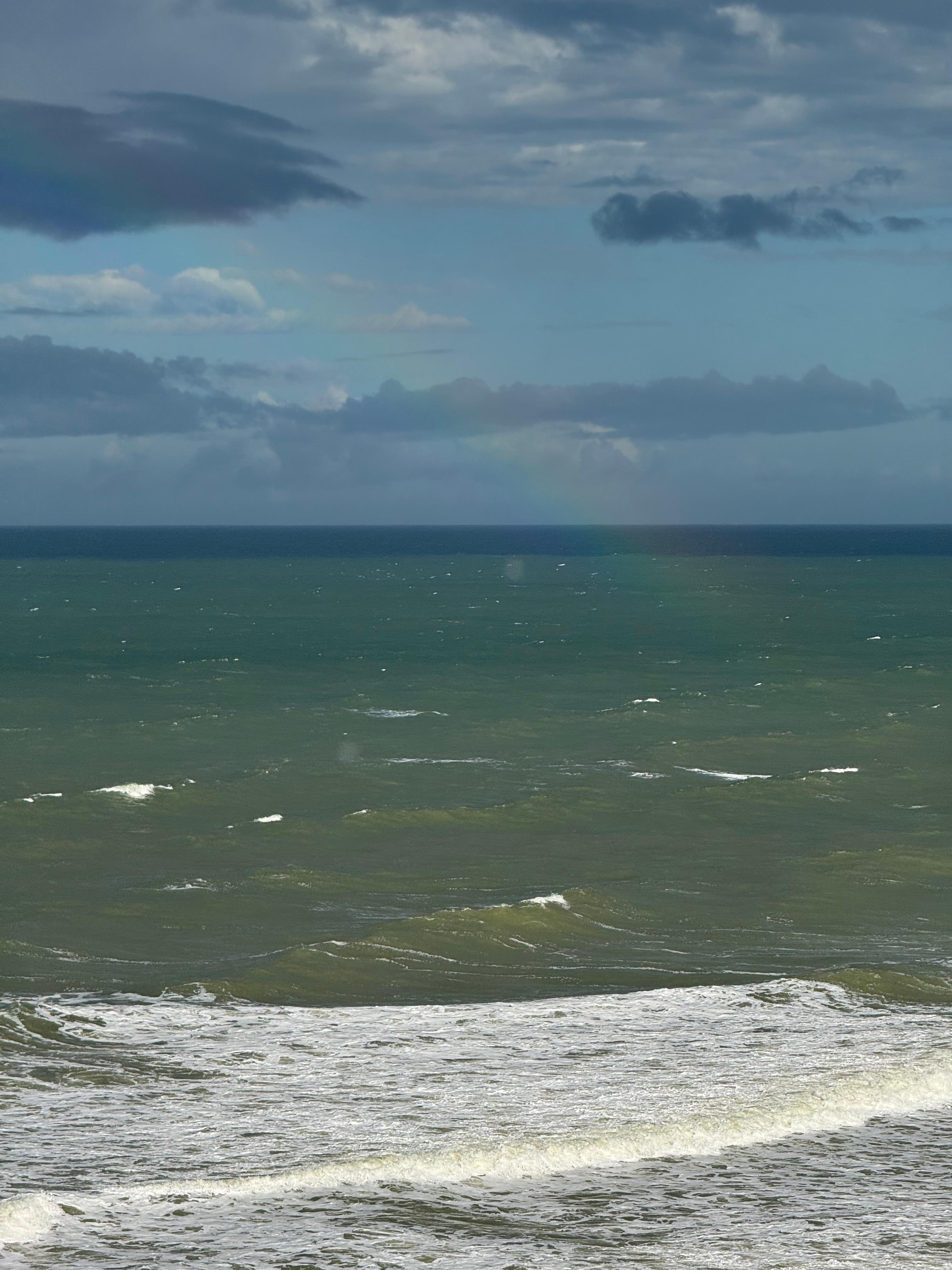 The rainbow rises from the sea... so poetic!