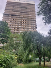 View of the apartment building, taken from a beautiful park behind the complex.