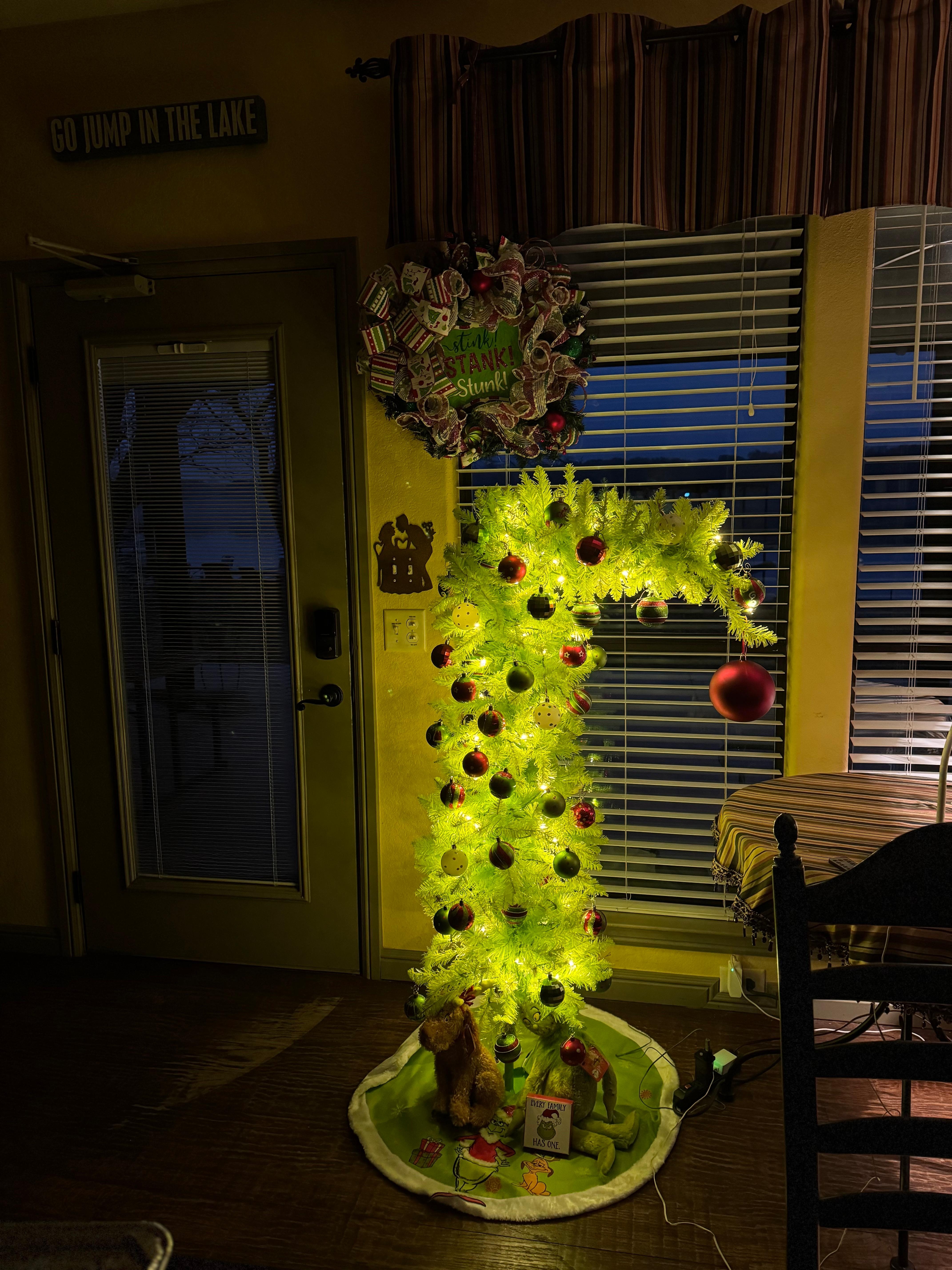 Our Grinch tree in the family room looking out onto the lake.