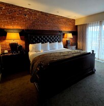 Cozy bedroom with fireplace and balcony.