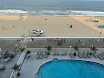 Views from balcony of pool, boardwalk and beach