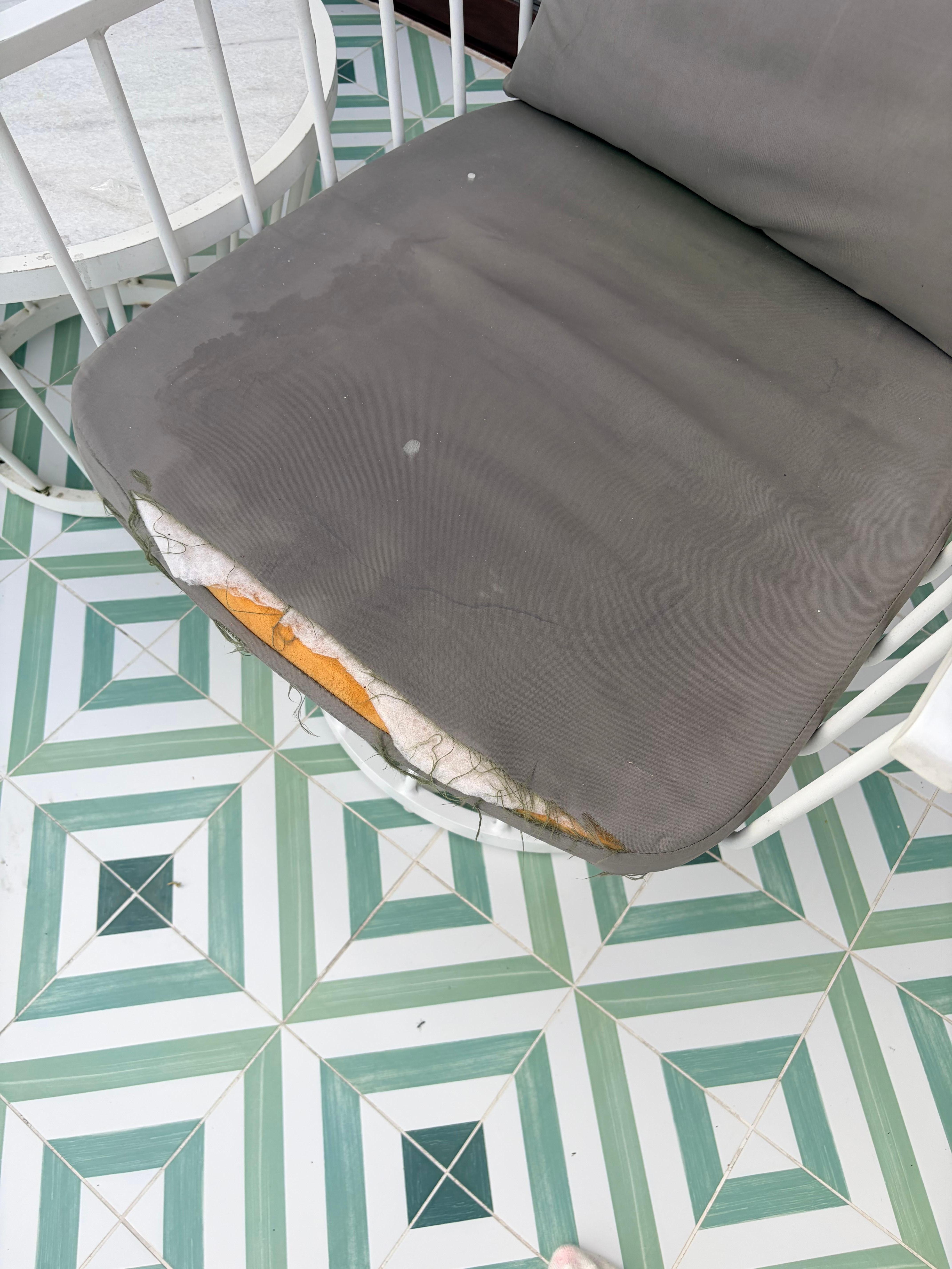 Patio chair cushion in first room