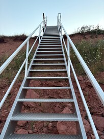 Stairs from cottage grounds to red cliff shore