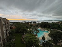 View of the pool and beach from the balcony.