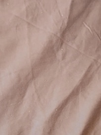 White flakes (feet crumbs) bottom of the bed.