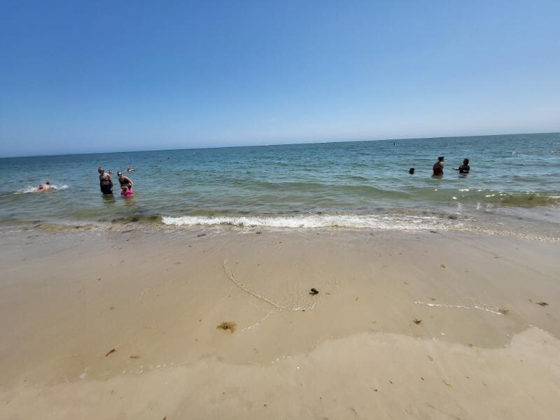 Calm, small waves, sand close to water