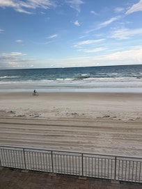 Bike rider on beach, view from balcony