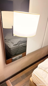 NO PLUGS beside the bed. How can you expect to charge a phone?? I repeat, NO PLUGS.