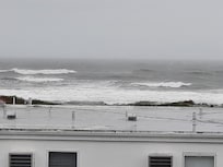 Off the end of the balcony.