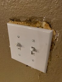 Spray foam behind the light switch plate - major safety hazard