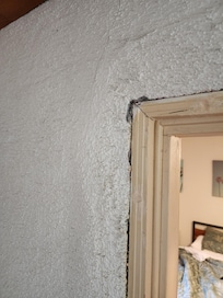 No door trim! This is a main doorway from the kitchen area to the bedroom / living area. It either is unfinished or finished with a horrible outcome.