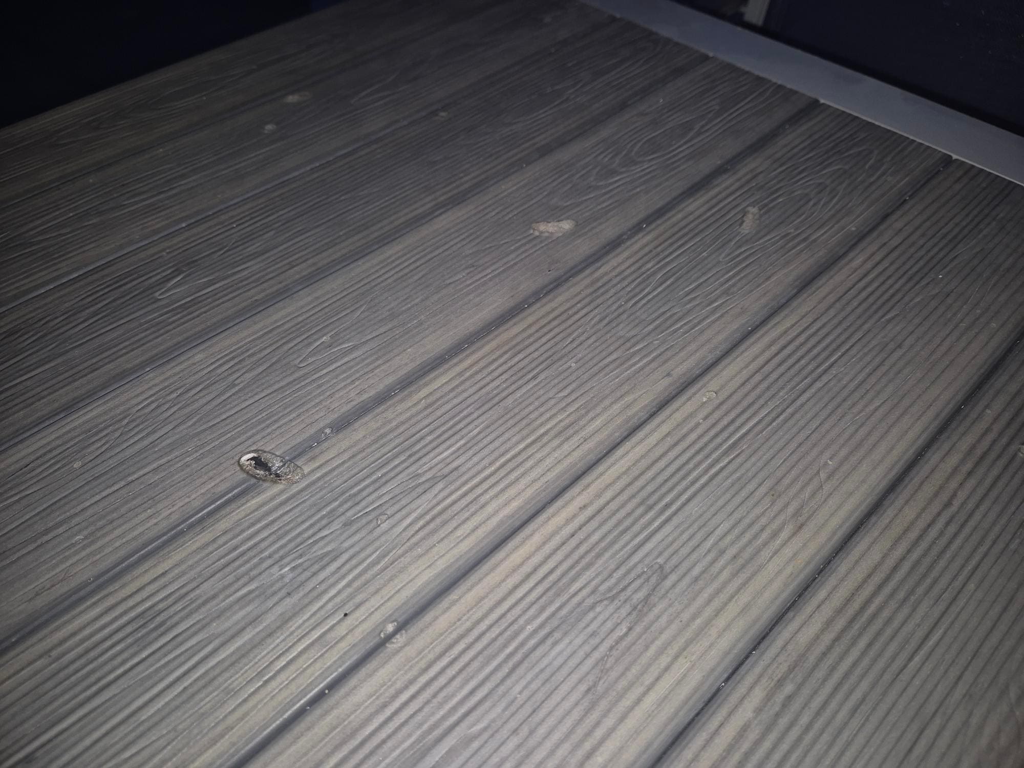 Cigarette marks on the patio table #1.